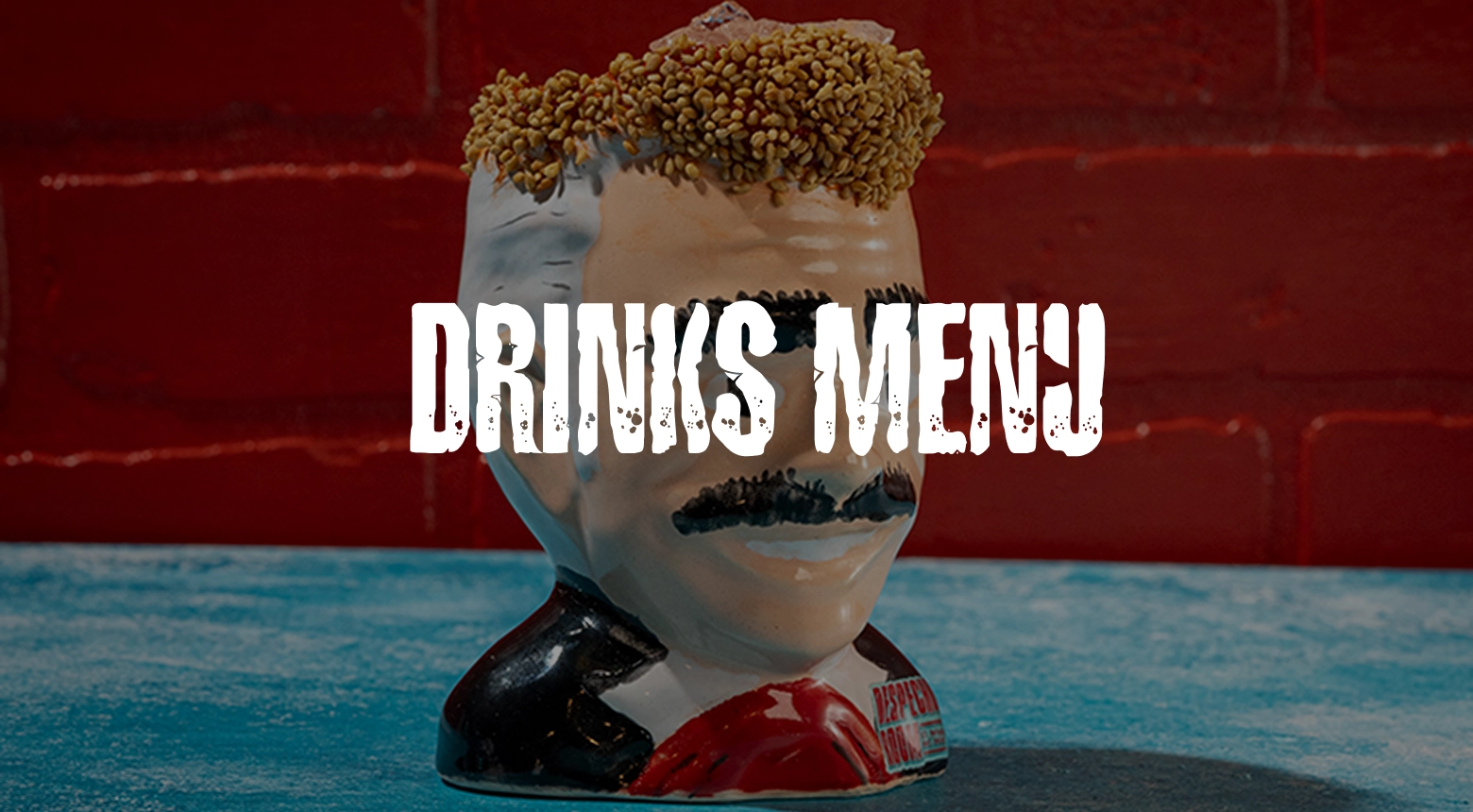 A specialty cocktail in a character mug, representing the unique drinks menu at Despecho Room in Garfield, NJ.